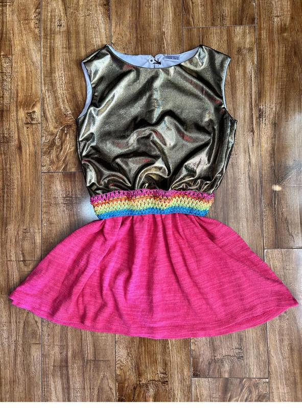 Gold top with rainbow waistband and pink skirt