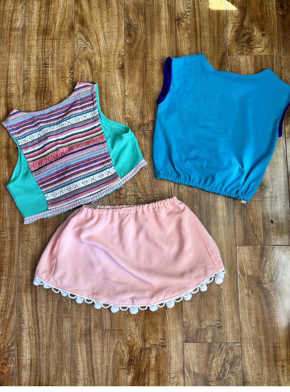 Striped crop top, blue top and peach pom-pom skirt